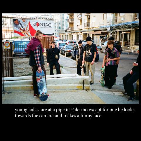 young lads stare at a pipe in Palermo except for one he looks towards the camera and makes a funny face (feat. DJ TUPAPA)