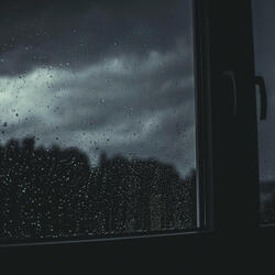 rain pours on a window