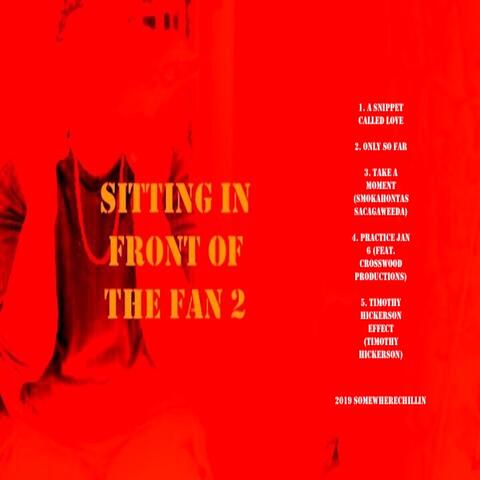 sitting in front of the fan 2